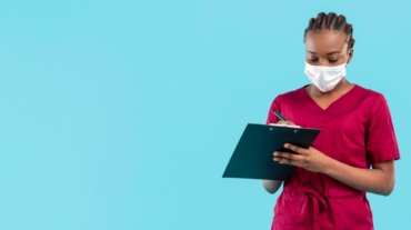 female-doctor-wearing-mask-writes-clipboard (2)