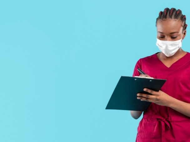 female-doctor-wearing-mask-writes-clipboard (2)