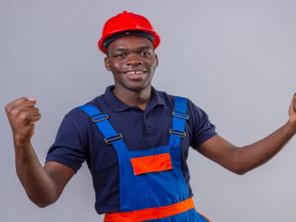 young-african-american-builder-man-wearing-construction-uniform-safety-helmet-clenching-fists-smiling-standing-with-happy-face-celebrating-victory-winner (1)